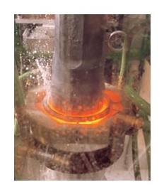 Induction heating of a solid shaft and quenching with water